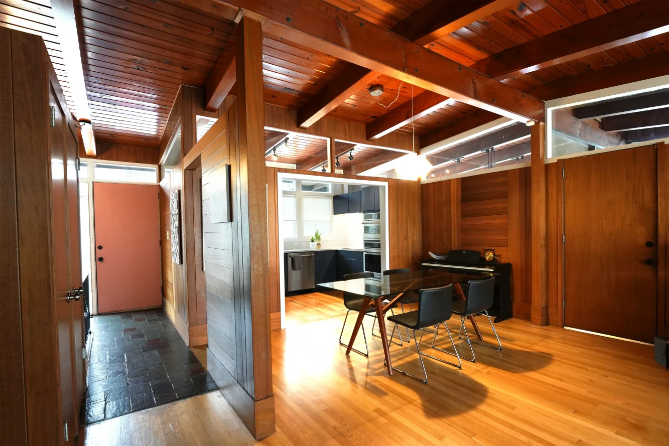 A view toward the newly opened up kitchen showing fluid connection to dining room for this mid-century modern home