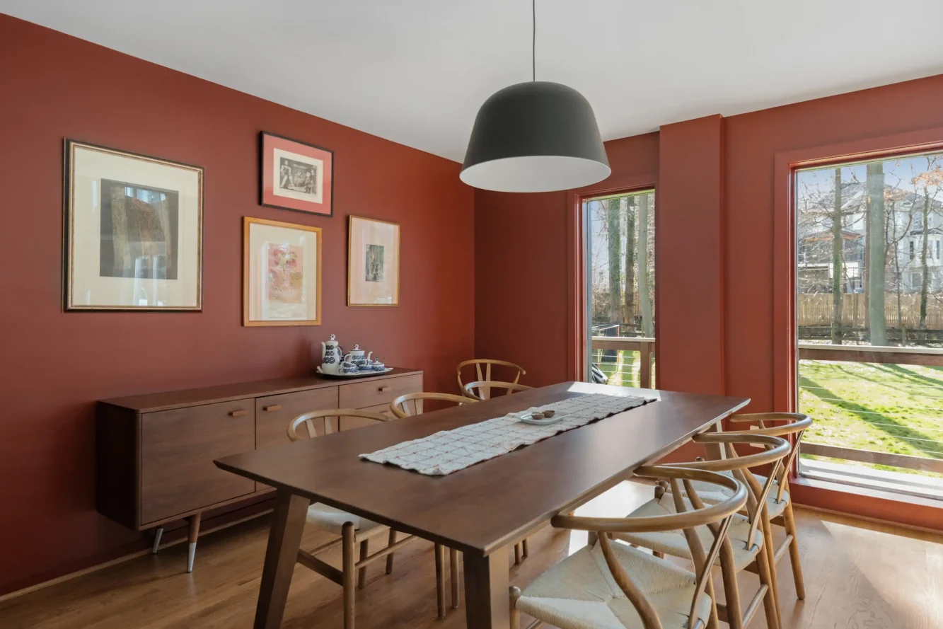 View of dining area with new mid-century modern sideboard, table and chairs and large matte black "Ambit" pendant by Muuto