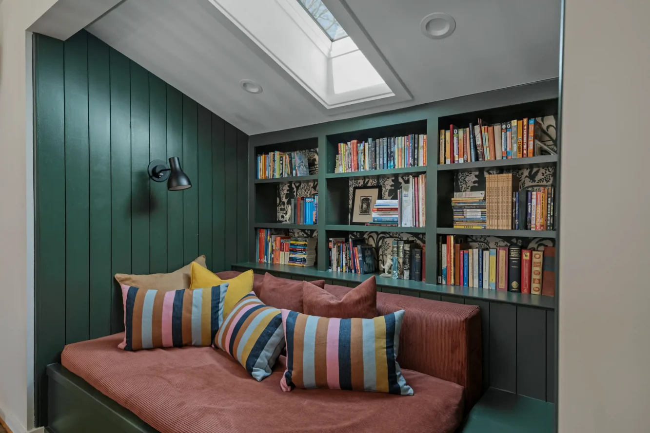 A new, built-in Moroccan style reading niche located on the mezzanine where a old bath with compromised headroom once lived is a coveted feature in this household of readers