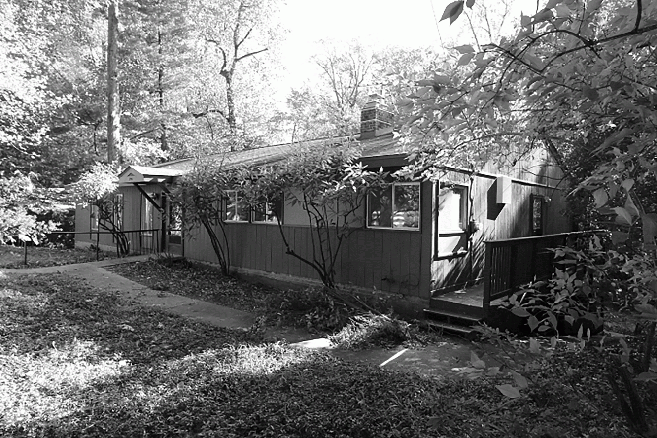 View from the street of the existing dilapidated home. 