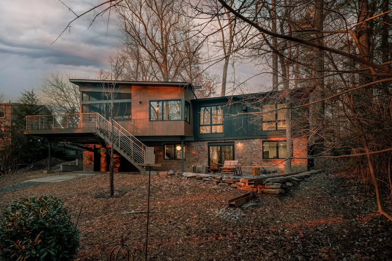 View of the setting sun on the very private back yard as it faces Rock Creek Park and newly renovated and expanded rear of the home